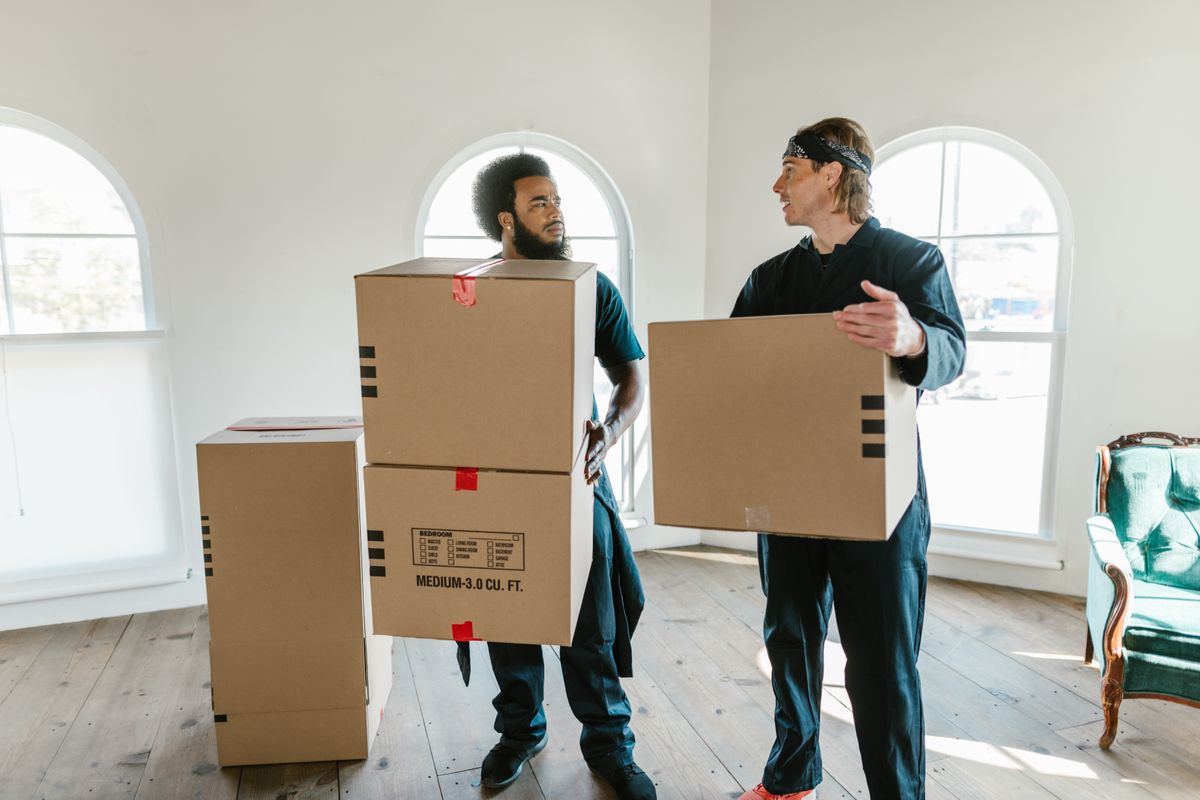 MMJ Resources movers carrying a large box together
